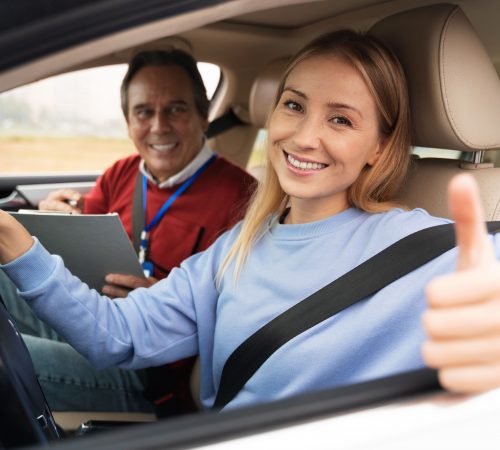 woman-and-male-driving-instructor-during-driving-test (1)